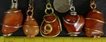 Wire wrapped Carnelian agates on necklaces. Carnelians are orange agates with various shades of brown and yellow. They are often translucent, and may have swirls or specks of white or brown