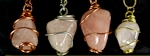 Rose quartz tumbled stones wire wrapped pendants on necklaces. Rose quartz stones are a light pink form of clear quartz. They are usually translucent